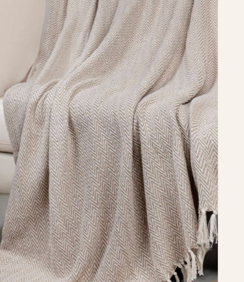 Soft neutral Vingrow throw blanket on a bed